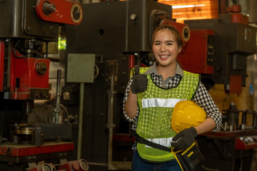 Poster - Portrait of a worker in the helmet working at factory with Various Metalworking Processes,Industrial background.