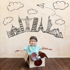 Wall Mural - Happy child playing with toy airplane