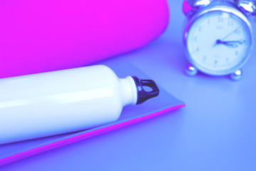 Bright purple yoga mat and bottle of water