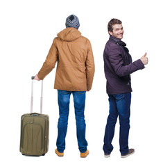 Sticker - Back view of two man in winter jacket traveling with suitcas.