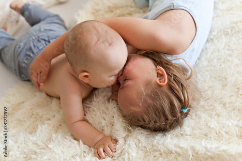 Two caucasian siblings brother and sister lying on bed at home Tableau sur Toile