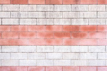 Wall Mural - Eine verwitterte rot weiß rote Ziegelsteinmauer als Hintergrund