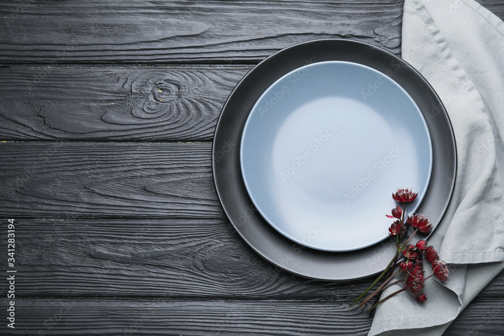 Clean napkin with plates on wooden background