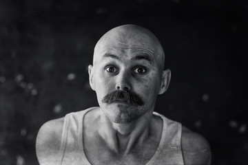 unusual portrait of a bald mustachioed young gentleman, eccentric mister, psychology concept