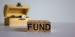 © Dzmitry - Concept word fund on blocks on a beautiful white background, small chest with coins.