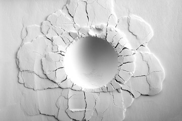a crater on white powder background. round crater with cracks.