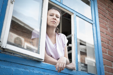 A woman looks out the window