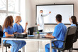 © Pixel-Shot - Male lecturer teaching medical students in university