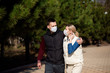 © nagaets - Young European man and woman in protective disposable medical mask walking outdoors afraid of dangerous NCoV 2019 influenza coronavirus mutated and spreading in China