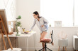© Pixel-Shot - Young female designer working at home