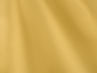 Abstract background, yellow elegant fabric or liquid waves or jagged edges. Seamless pattern of satin cotton.