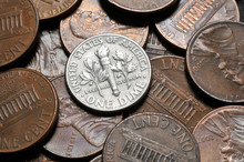 A Close Up Of An United States Dime Coin (10 Cents Coin) Surrounded By Pennies.
