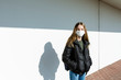 © Westend61 - Girl with mask standing in front of a white wall
