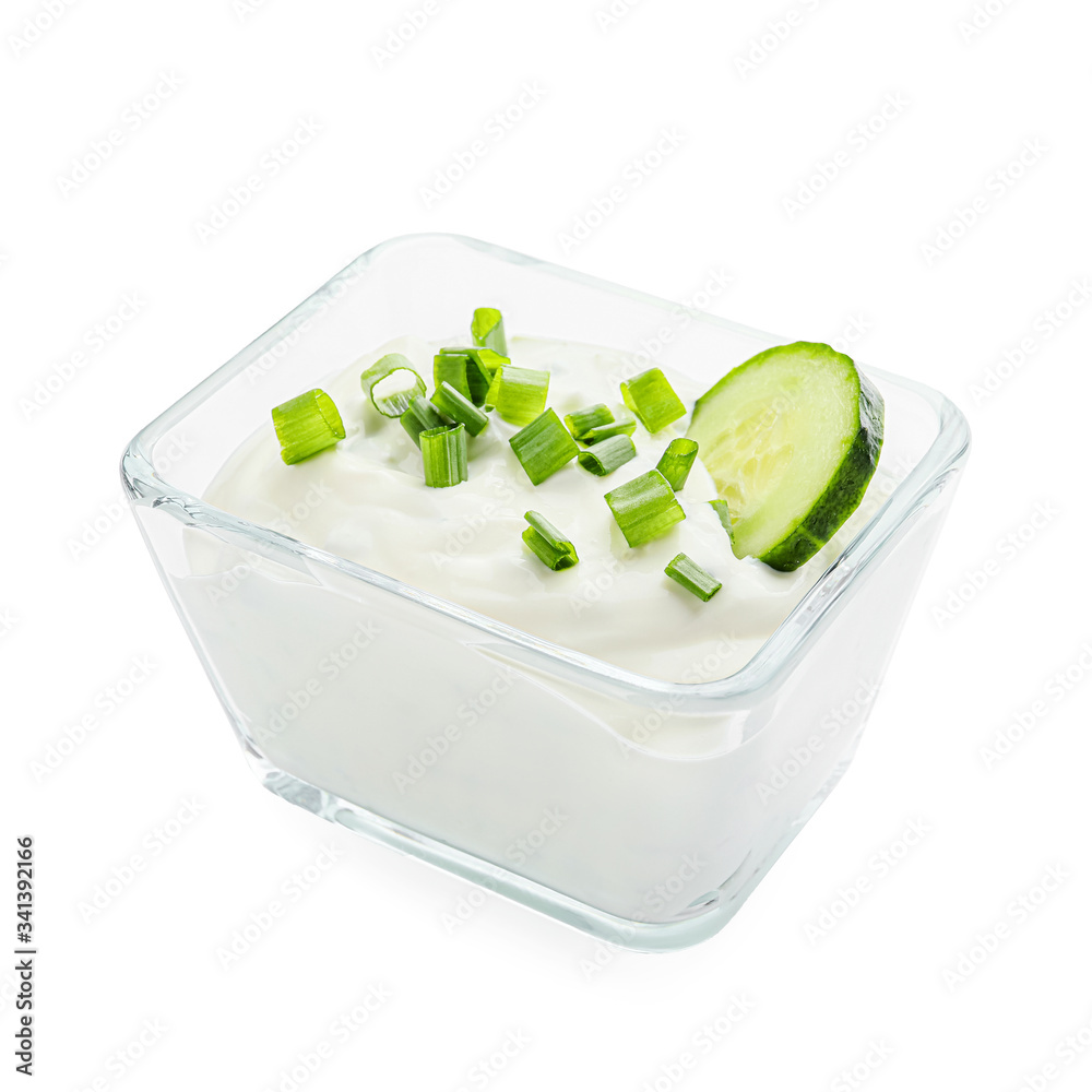 Delicious yogurt sauce with cucumber in bowl on white background