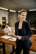 © Marat - Vertical portrait of a successful young business lady standing in the office