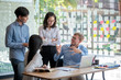 © amnaj - Teamwork of Asian business people discussing documents and plan financial graph analysis in the meeting room.