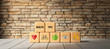 cubes with text HEALTH TIPS and health icons in front of a brick wall on a wooden floor