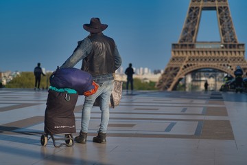 Fototapete - Homeless Person observing the beauty of Eiffel Tower in Paris, France during the lock-down period due to covid-19