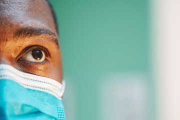 african american man in blue and white surgical  face mask