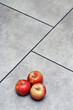 red apples, on grey floor tiles