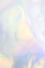 Abstract holographic purple pink background. Liquid neon rainbow foil in unicorn style. Marble iridescent futuristic texture. Trend style 90s.