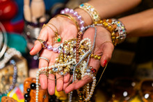 Cropped Hands Of Woman Holding Jewelries