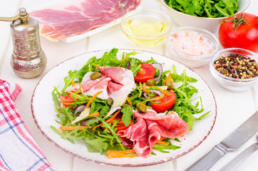 Wall Mural - Fresh homemade salad with arugula, jamon, rucola, tomatoes, parmesan.