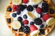 © Brett - Perfect belgian waffle closeup with fresh bananas, strawberries, blackberries, blueberries and whipped cream