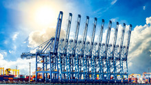Harbor Cargo Cranes Shipping Port Equipment, Industrial Port Crane, Logistics Business Huge Cranes And Containers, Cargo Freight Ship With Industrial Crane, Container Ship In Import Export Business.