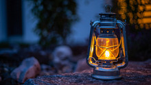 Close-up Of Illuminated Lantern On Rock A T Night