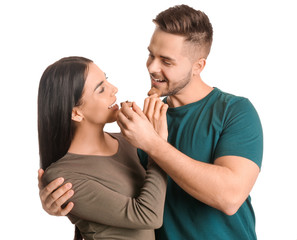 Wall Mural - Beautiful young couple with tasty chocolate on white background