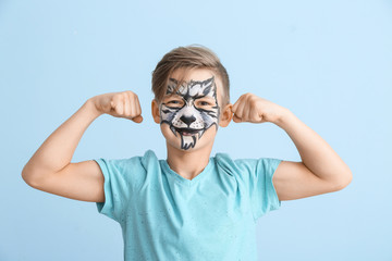 Wall Mural - Funny little boy with face painting on color background