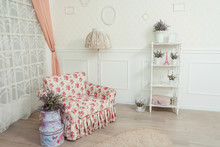 A Flower-print Armchair In A Bright Room In A Classic Style. The Interior Of The Room In The Style Of Shabby Chic. Beautiful Delicate Romantic Interior Of The Living Room