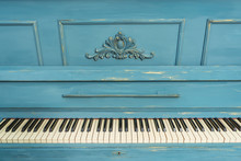 Keys Of An Old Piano. Details Of The Design Of The Recolored Blue And Gold Piano. Stucco On The Piano