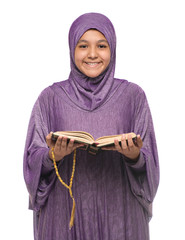 Wall Mural - Beautiful Arab Muslim Girl in Islamic Fashion Dress Holding Holy Book of Quran With Happy Smily Face