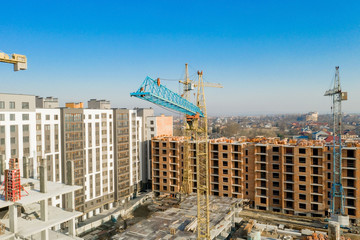 Construction and construction of high-rise buildings, the construction industry with working equipment and workers. View from above, from above. Background and texture