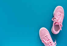 Pink Nubuck Sneakers Isolated On A Turquoise Blue Background, Seasonal Shoes For Walking And Sports, Top View