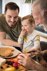 Grandpa is a master in the kitchen, his grandson is there to eat his specialties.