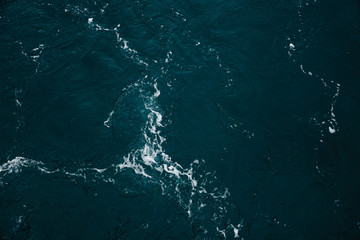 Blue ocean water texture, surface. Top view of aqua blue clear sea ocean. Beautiful blue sea water background.