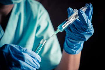 Nurse holding a syringe with the coronavirus COVID-19 vaccine