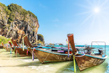 Fototapeta Morze - Thai traditional wooden longtail boat and beautiful sand beach at Koh Poda island in Krabi province. Ao Nang, Thailand ,Krabi island is a most popular tourist destination in Thailand