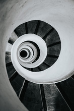 Black And White Image Of Spiral Stairs Looking Down From The Top, Creating An Interesting Perspective. 