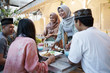 © Odua Images - muslim friend eating together. iftar ramadan. happy asian people wear hijab