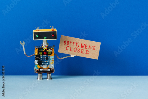 Sorry, we are closed. Crisis bankruptcy or service not available concept. Closed for maintenance or vacation. Robot handyman holds poster with handwritten apologizing message.