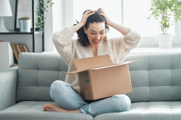 Wall Mural - woman is unpacking cardboard