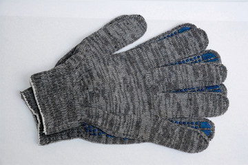 Paired work gloves in gray on a white background, top view.