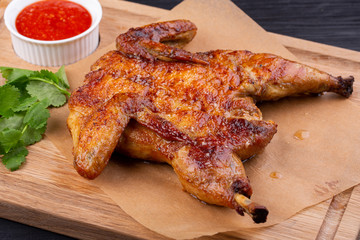 Chicken tobacco fried on coal with garlic, served with greens and ketchup