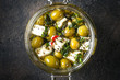 Feta with olives marinated in olive oil with spices. Meze is a dish of Mediterranean cuisine top view copy space.