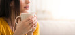 © Prostock-studio - Coffee break time. Unrecognizable millennial girl holding cup of hot beverage at home, closeup. Copy space. Panorama
