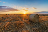 Hay Bales On Field Against Sky During Sunset